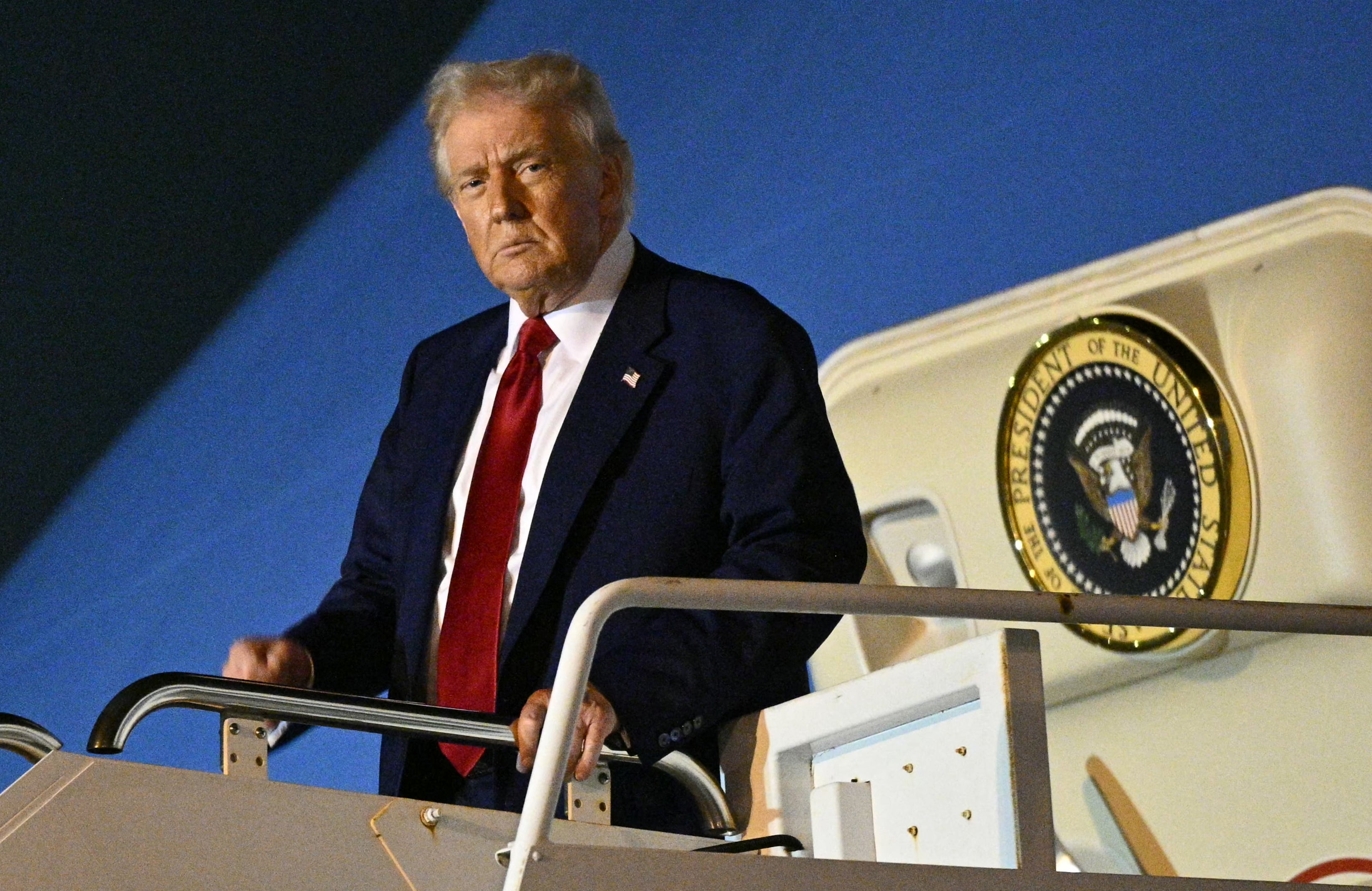 US President Donald Trump pumps his fist upon arrival at Miami International Airport on April 3, 2025. Trump is travelling to the Trump National Doral Golf Club before going to his Mar-a-Lago Resort. (Photo by Mandel NGAN / AFP)