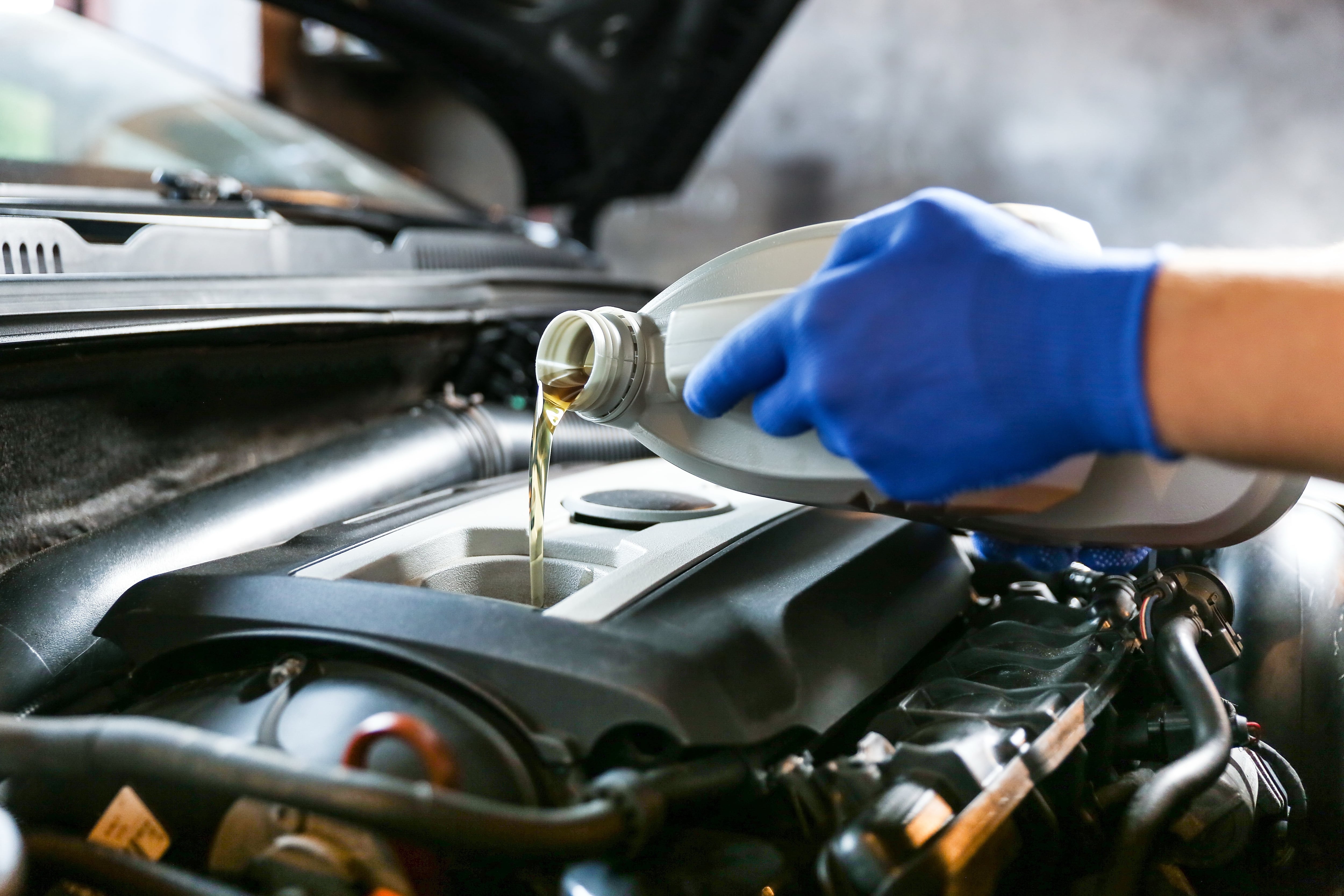 Car,Oil,Is,Poured,Into,The,Engine,Close,Up.,Pouring