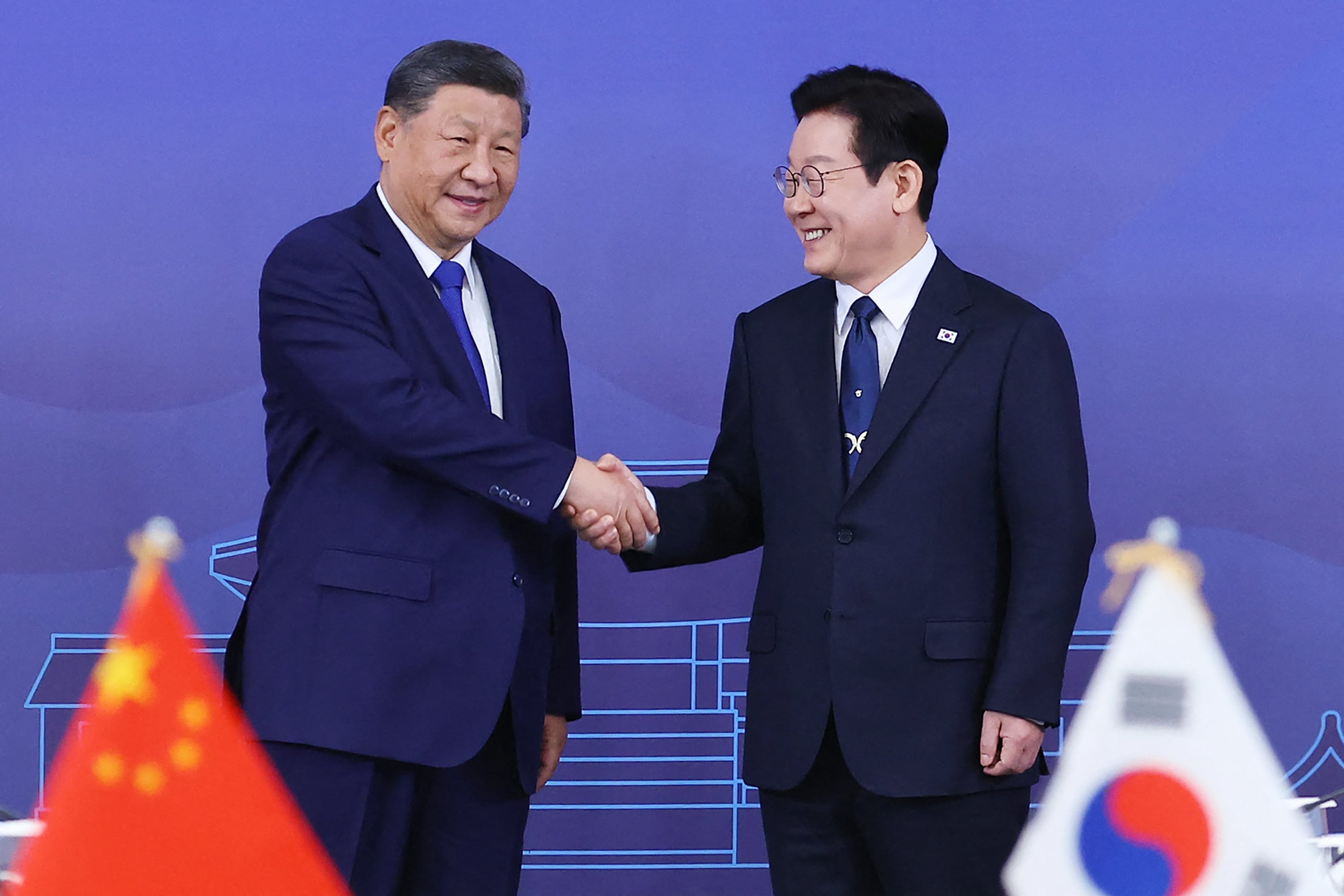 South Korea's President Lee Jae Myung (R) and China's President Xi Jinping shake hands ahead of the South Korea-China summit held at the Gyeongju National Museum in Gyeongbuk Province on November 1, 2025. (Photo by YONHAP / AFP) / NO USE AFTER NOVEMBER 11, 2025 08:39:52 GMT - - SOUTH KOREA OUT / NO ARCHIVES - RESTRICTED TO SUBSCRIPTION USE