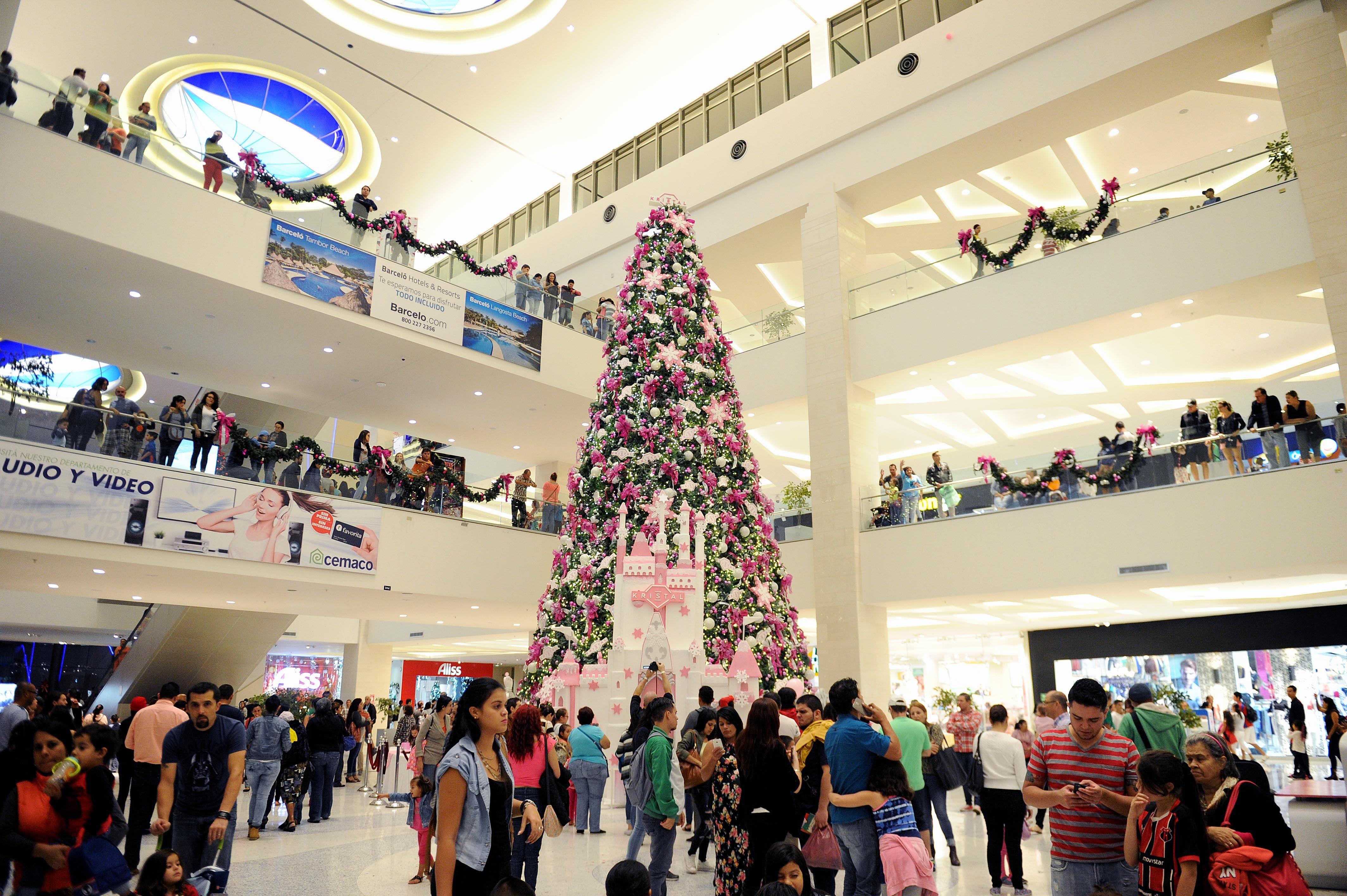 Árbol de Navidad decorado en el centro comercial City Mall con adornos rosados y blancos.