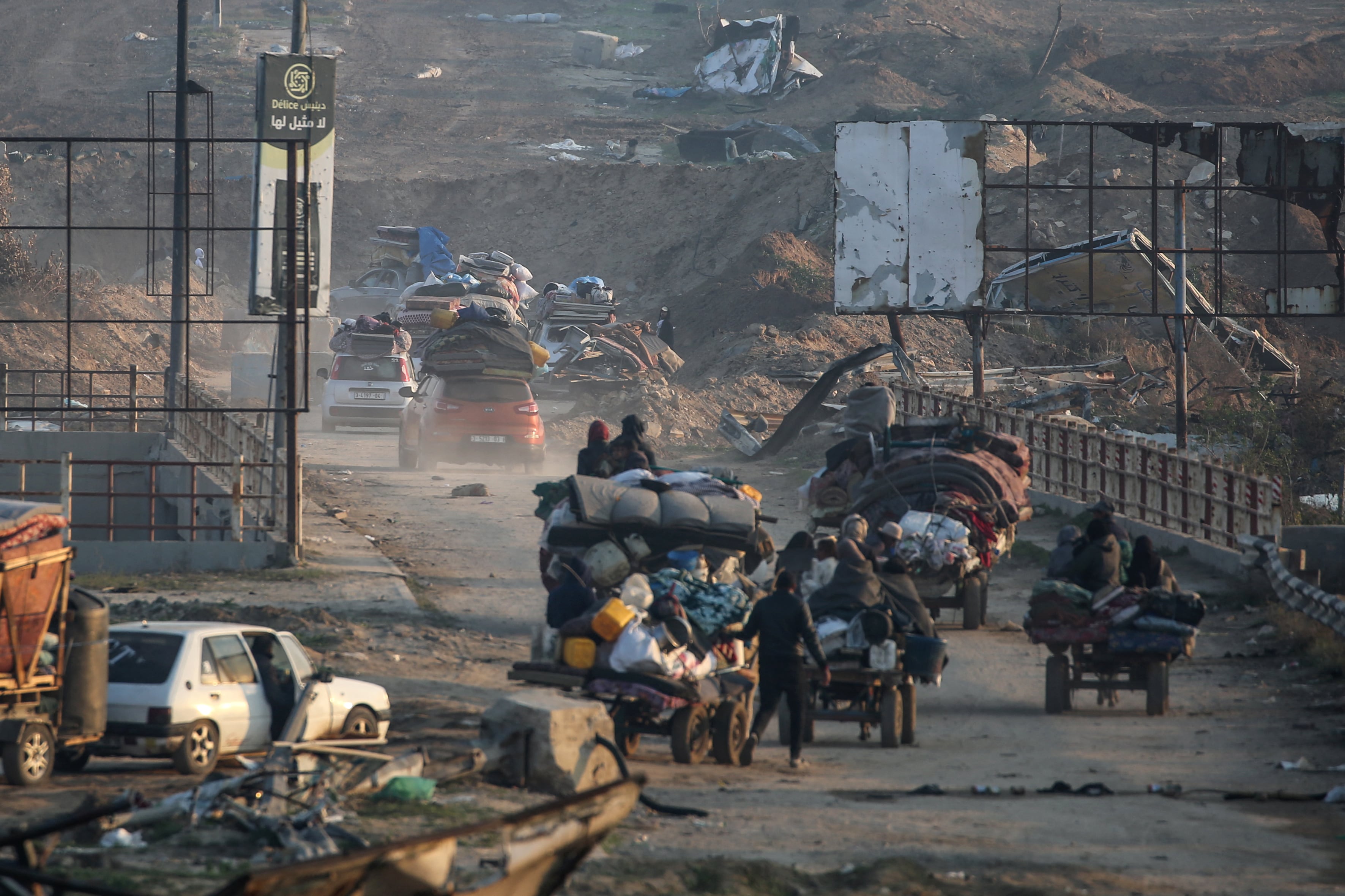 Palestinos desplazados cruzan una sección del corredor Netzarim mientras se dirigen desde el sur hacia el norte de la Franja de Gaza, en la carretera Saladino, en Mughraqa, en el centro de Gaza.