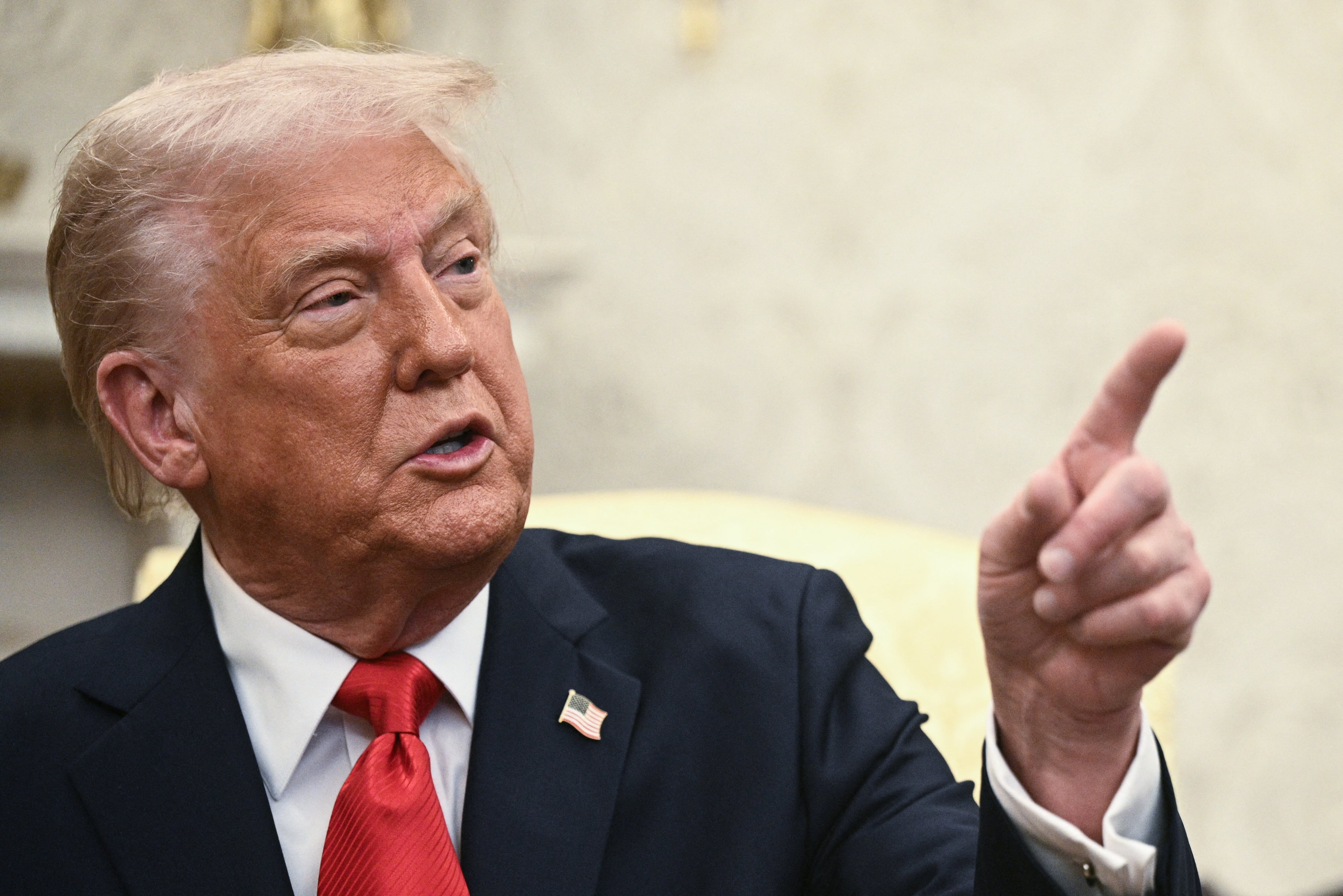 US President Donald Trump gestures after hosting the 2025 College Football National Champions, Ohio State Buckeyes, celebrating the team's title-winning season with a ceremony on the South Lawn of the White House in Washington, DC, April 14, 2025. (Photo by Brendan Smialowski / AFP)
