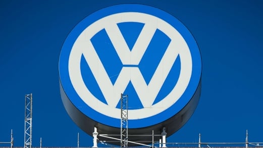 (FILES) This picture taken on September 30, 2015 shows a worker standing on a scaffold lift, under a giant Volkswagen logo at VolksWagen's original headquarters building, now under renovation in Wolfsburg, northern Germany. Michael Horn, president and chief executive of Volkswagen Group of America, apologized to Congress and said the company takes "full responsibility" for the emissions cheating scandal, according to testimony released on October 8, 2015. AFP PHOTO / JOHN MACDOUGALL