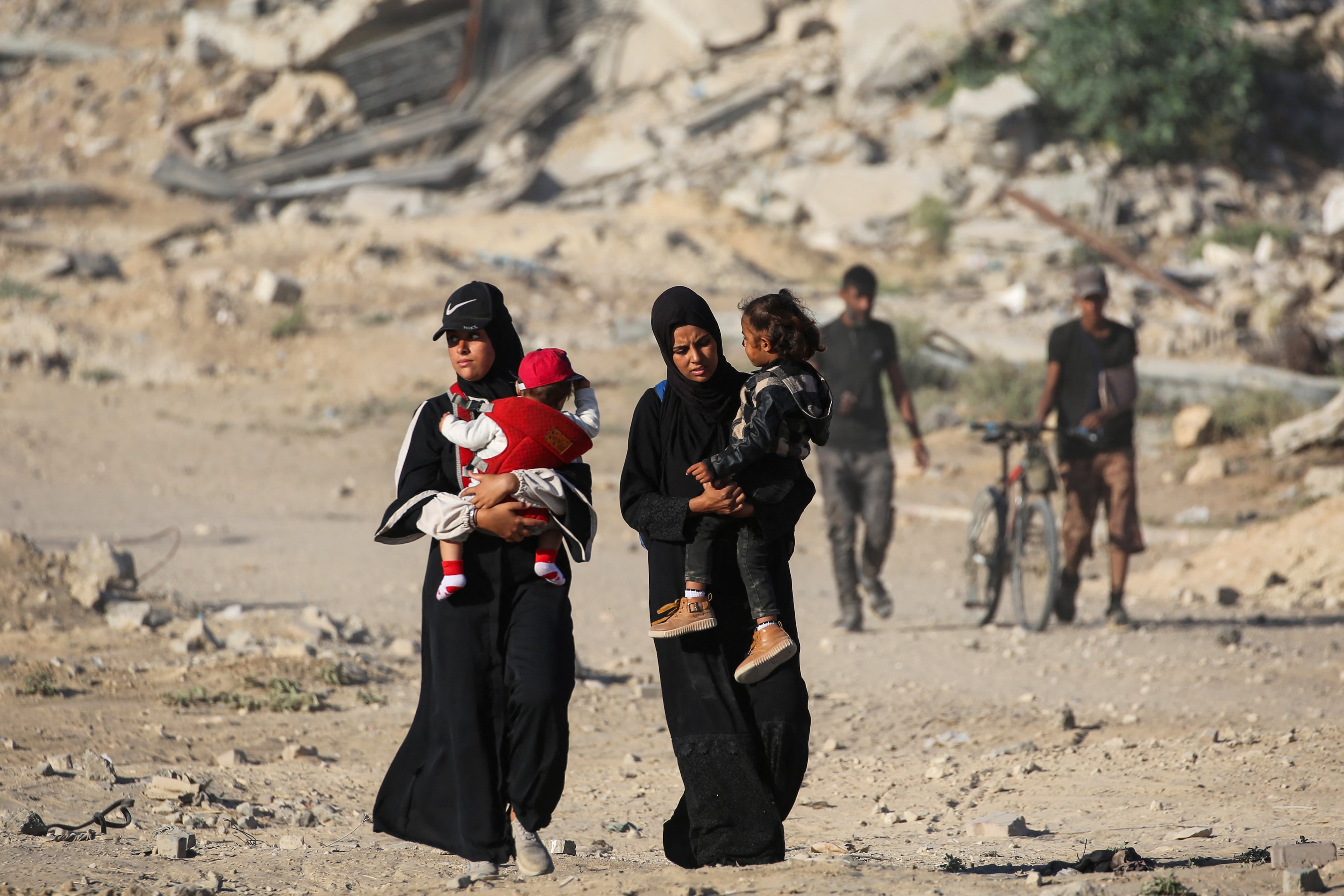 Mujeres palestinas con sus hijos caminan juntas por el llamado "corredor Netzarim" en su camino a la ciudad de Gaza desde Nuseirat, en el centro de la Franja de Gaza, este 11 de octubre. Fotografía: