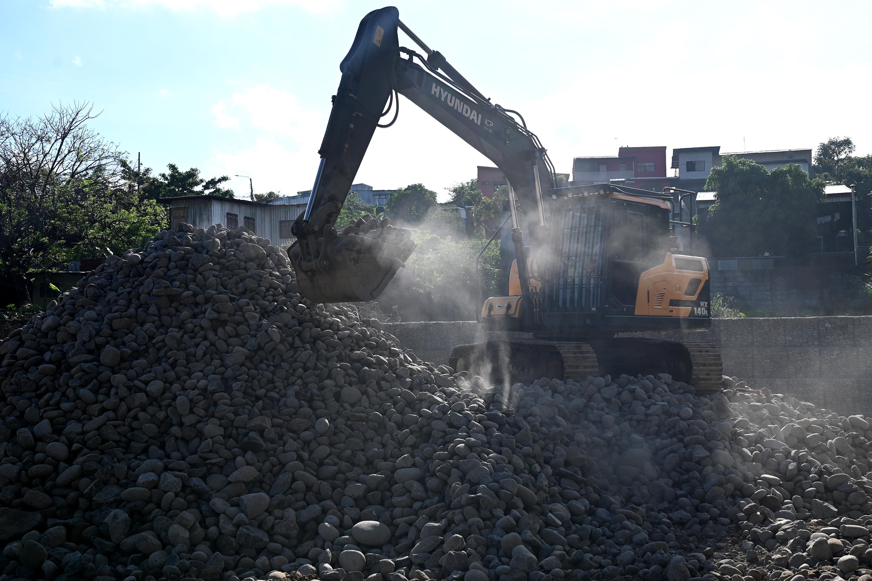 04 de abril del 2025. San Rafael Arriba de Desamparados. Río Cañas. 06:00 hrs. Maquinaria y personal de una empresa constructora privada realizan la construcción de varios muros de retención (gaviones) a lo largo del río Cañas al sur de la capital. La obra es financiada por el BCIE (Banco Centroamericano de Integración Económica) y gestionada por la Comisión Nacional de Emergencias. El proyecto beneficiaría a unas 24000 personas de comunidades como Calle Robles, San Bosco, Blanca Durán y La Granja que sufrieron serios daños con las lluvias del año anterior. Algunos vecinos del lugar externaron su molestia pues consideran que se refuerzan orillas del cauce del río pero se debilitan otras. En la foto: maquinaria pesada y personal de una constructora privada realizan las labores en el río Cañas. Foto: Albert Marín para la Nación.
