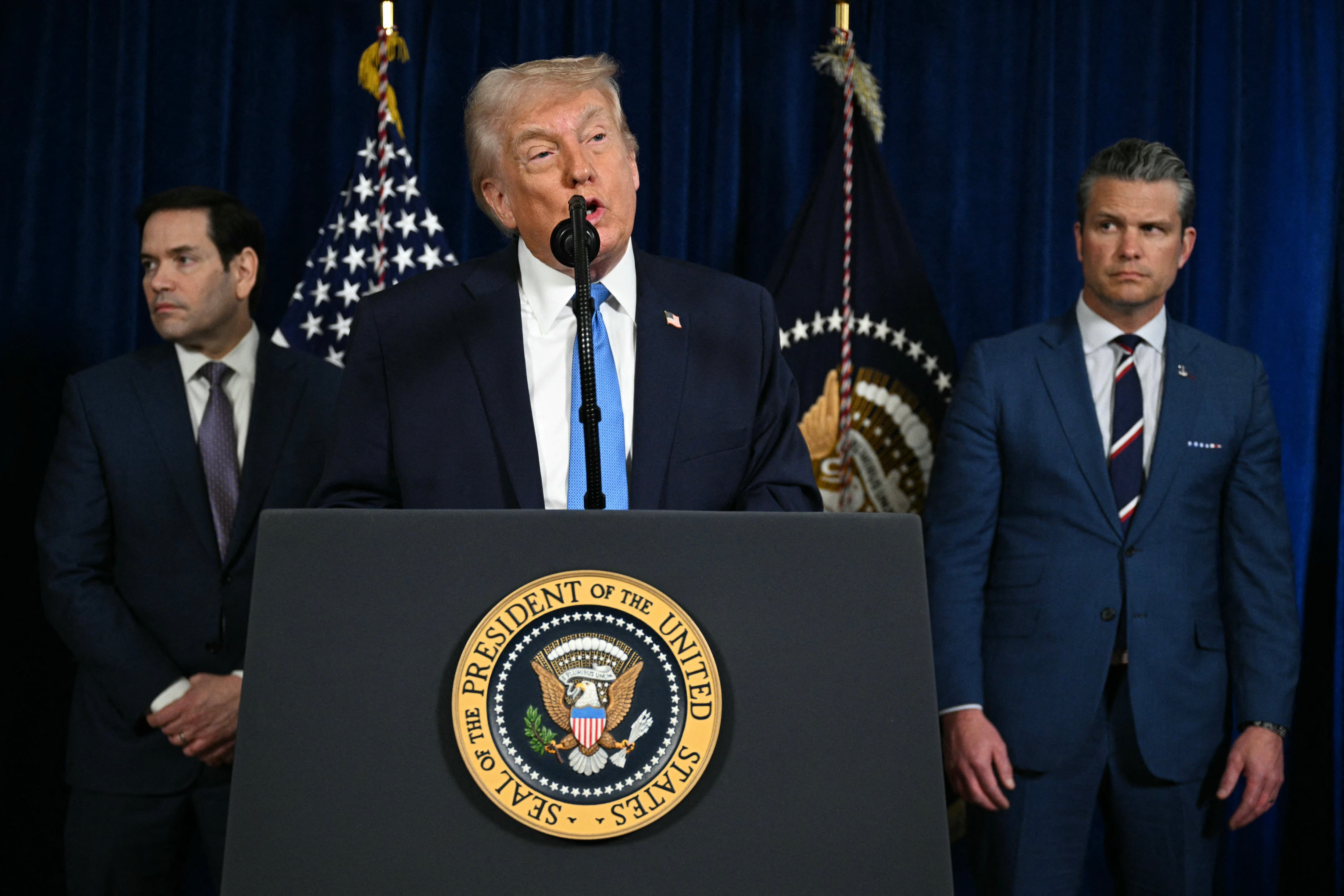 US President Donald Trump, alongside Secretary of State Marco Rubio (L) and US Secretary of Defense Pete Hegseth (R), speaks to the press following US military actions in Venezuela, at his Mar-a-Lago residence in Palm Beach, Florida, on January 3, 2026. President Trump said Saturday that US forces had captured Venezuelan leader Nicolas Maduro after launching a "large scale strike" on the South American country. (Photo by Jim WATSON / AFP)