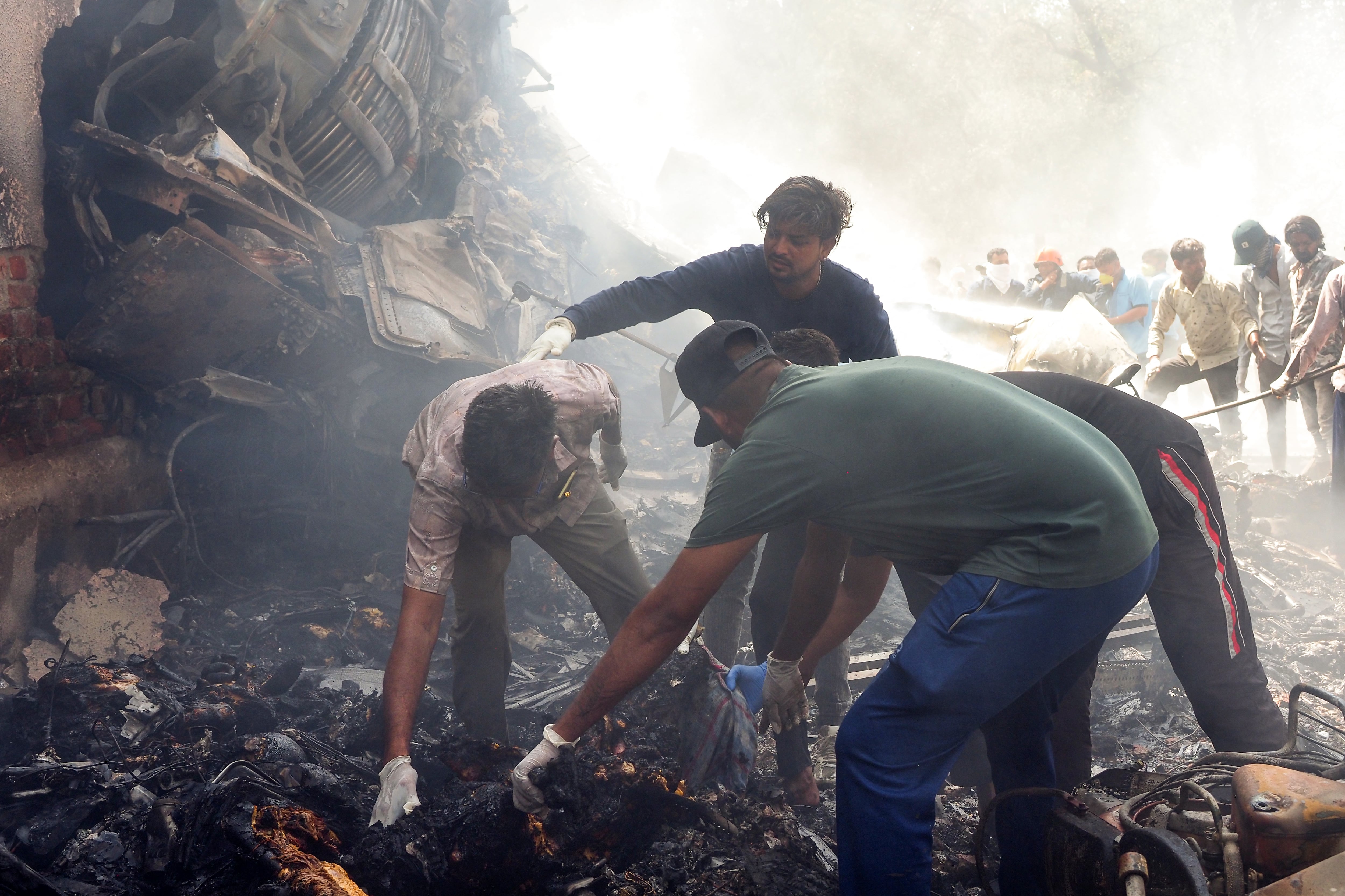 (FILES) Rescue officials work at the site where Air India flight 171 crashed in a residential area near the airport in Ahmedabad on June 12, 2025. Indian investigators have successfully retrieved data from the black boxes of a London-bound Boeing plane, the government said on June 26, after the passenger jet crashed in one of the deadliest air disasters in decades, killing at least 265 people on board and on the ground. (Photo by Sam PANTHAKY / AFP)