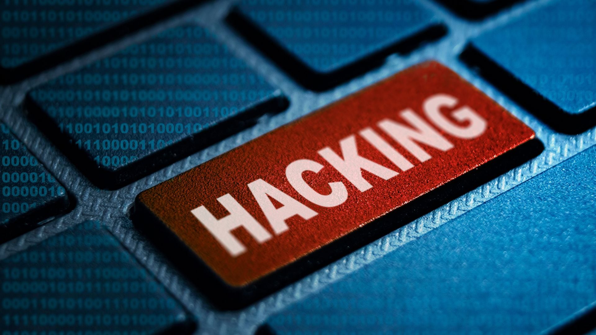 Teclado azul con una tecla roja que dice "Hacking", simbolizando ciberataques relacionados con ransomware en Costa Rica.